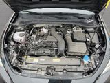 the engine of a car with its hood open on the street