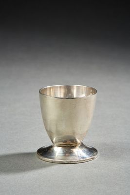 a silver cup sitting on top of a saucer