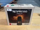 a box of nespresso espresso mini coffee machine on a table