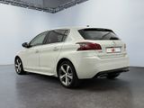 the rear end of a white car parked in a garage
