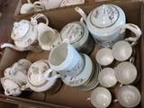 a lot of tea pots and cups in a box