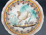 a colorful plate with a bird and palm trees on it
