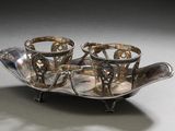 a silver tray that has three cups on it