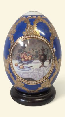 a blue and gold egg with a picture on it