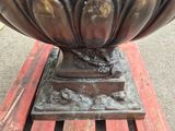 a large metal bowl sitting on top of a wooden table