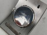 a close up of a silver watch on a white surface