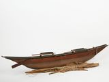 a wooden boat that is sitting on the ground