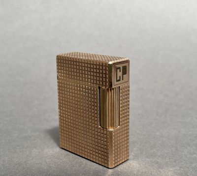 a gold lighter that is sitting on a table