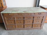 a wooden cabinet with many drawers and a marble top