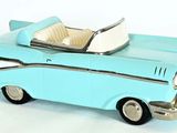 a blue toy car that is sitting on a white surface