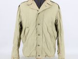 a beige jacket on a mannequin head on a white background