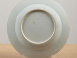 a white plate with a gold rim sitting on a table