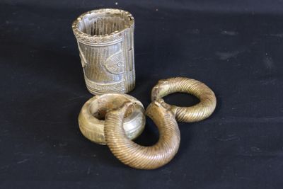 a snake that is standing next to a cup