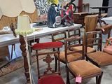 many chairs and a table with a lamp on it