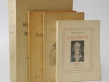 three books sitting on top of each other on a white surface