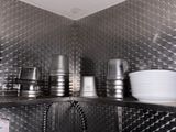 plates and cups on the shelf in the kitchen
