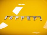 the emblem of a yellow sports car is seen in this image