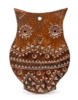 an image of a brown and white owl shaped object on a white surface