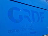 a blue bus with the word grdf written on it