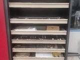 a red cabinet that has a bunch of shelves in it