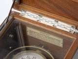 a wooden box with a clock inside of it