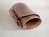 a brown leather case with a red string on it