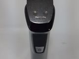 an electric shaver on a white surface with a white background