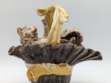 a vase with a figurine of a woman and a cat in it