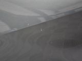 a close up of a car door with a hole in it