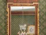 a mirror hanging on the wall above a sink