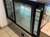 a glass display case in the middle of a store