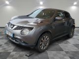 a picture of a grey nissan juke suv parked in a showroom