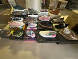 many pairs of shoes that are sitting on a table
