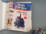 many toy cars on the table next to a magazine