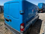 a blue van that is parked on the side of the road