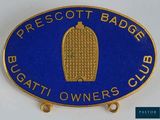 a close up of a badge on a white surface with a blue background