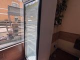 a refrigerator that is sitting in a room by a window