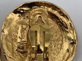 two gold colored buttons with a picture of a man and a woman on them