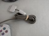 a cable connected to a video game controller on a table