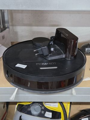 a black and silver vacuum on a shelf in a room
