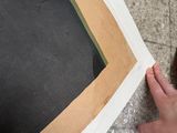 a person standing next to a piece of paper on the ground