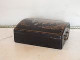 a small black box sitting on the floor next to a wall