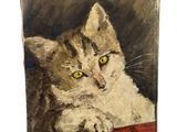 une peinture à l'huile représentant un chat allongé sur une couverture rouge
