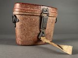 a small brown box with a wooden spoon in it
