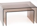 a close up of two clear glass tables on a white background