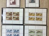 four different stamps are displayed on a wall with a picture of a woman
