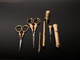 three pairs of scissors and a pair of scissors on a table