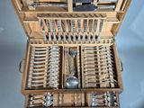 a wooden box with a bunch of silverware in it