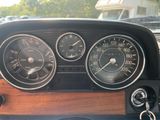 a close up of a car dashboard with gauges and speedometers