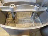 a metal bowl with springs in it on a table